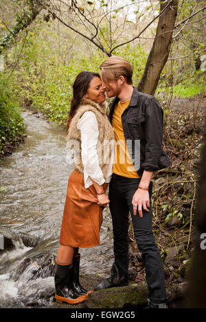 Woman and man about to kiss near creek. Stock Photo