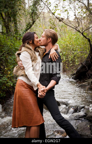 Woman and man kissing in the creek. Stock Photo