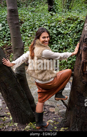 Woman standing in middle of tree. Stock Photo