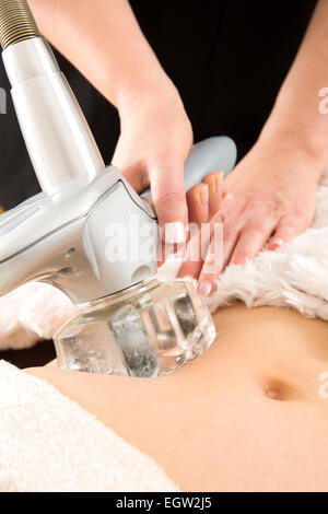 Woman receiving vacuum treatment at body clinic Stock Photo