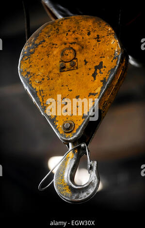 Industrial metal yellow hook detail shot inside a factory Stock Photo