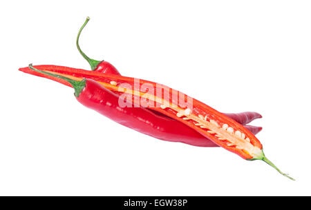 Two whole and one half red chili peppers deployed isolated on white background Stock Photo