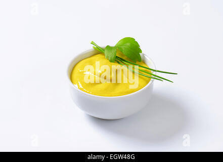Bowl of smooth Dijon mustard Stock Photo