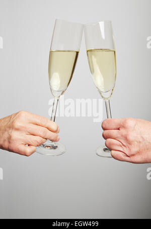 Drinking champagne in a glass for celebration at New Year's Eve Stock Photo