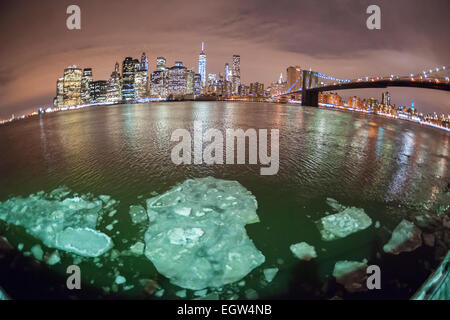 The New York skyline is seen across the East River from Brooklyn on Tuesday, February 24, 2015. Chunks of ice floating in the river due to the cold weather has caused the ferry service to be suspended on Tuesday. The East River boats are smaller than the one used on the Hudson River and would be more prone to damage. (© Richard B. Levine) Stock Photo