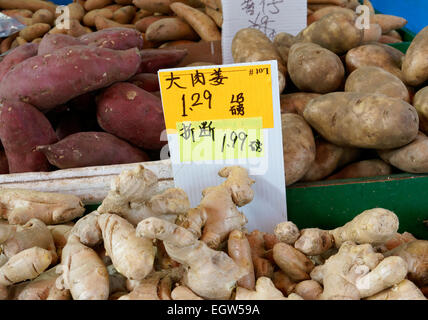 Ginger root, sweet potatoes, and yams for sale in Chinatown, Vancouver, BC, Canada Stock Photo