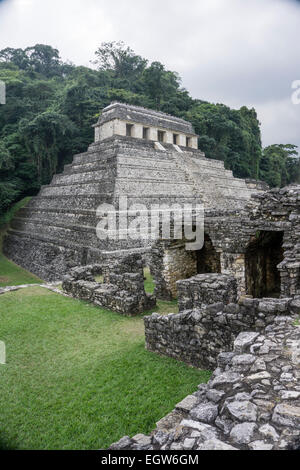 stepped pyramid structure Temple of the Inscriptions seen from grassy upper terrace of Palacio Palace Palenque Chiapas Stock Photo