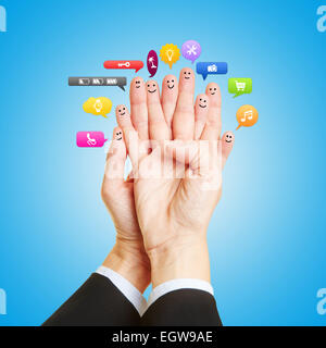 Group as smileys on fingers talking with many colorful speech bubbles Stock Photo