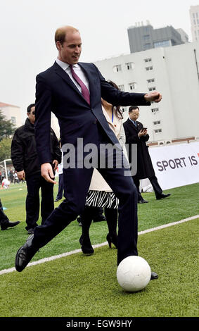 Shanghai, China. 3rd Mar, 2015. Britain's Prince William kicks a ball during a visit to a Premier League training camp at Nanyang Secondary School in Shanghai, east China, March 3, 2015. Credit:  Jin Liangkuai/Xinhua/Alamy Live News Stock Photo