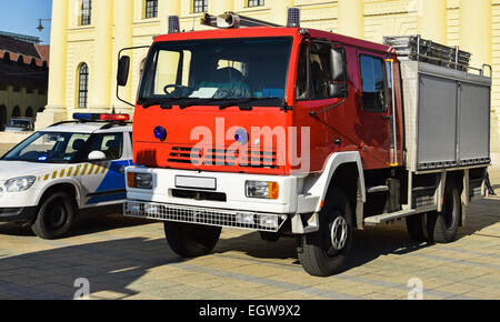 Firefighter truck and a police car on the street Stock Photo
