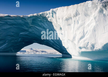 Antarctica, Weddell Sea, large Antarctic iceberg with natural arch through Stock Photo