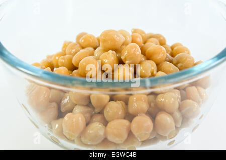 Close up of chick peas in glass bowl on white background Stock Photo