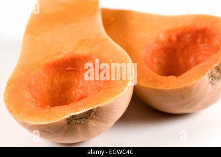 Butternut squash cut in half and deseeded on white background Stock Photo