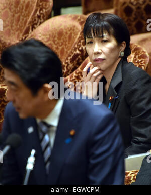 Tokyo, Japan. 3rd Mar, 2015. Sanae Takaichi, background, Japan's minister of internal Affairs and communications, looks at Prime Minister Shinzo Abe as he answers an opposition lawmaker during a budget commettee deliberation at the Diet's lower house in Tokyo on Tuesday, March 3, 2015. Credit:  Natsuki Sakai/AFLO/Alamy Live News Stock Photo