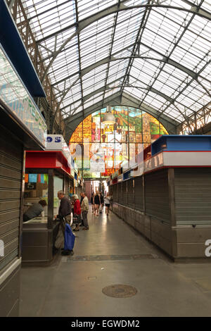 Interior of Atarazanas, covered Market with closed vendor kiosks in Malaga, Andalusia, Spain.