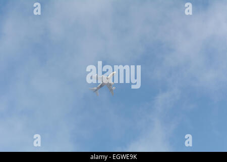 Emirates airplane approaching Gatwick Airport on cloudy day viewed from Reigate, Surrey, England Stock Photo