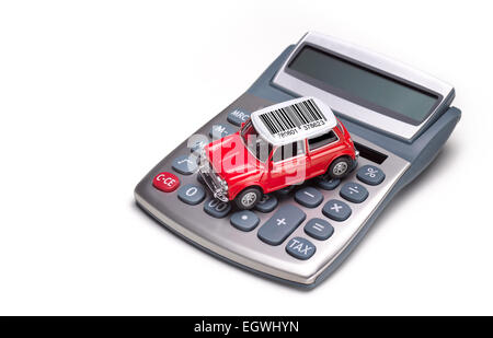 the cost of buying a car, cost of motoring, red car shot from above on calculator on white background Stock Photo