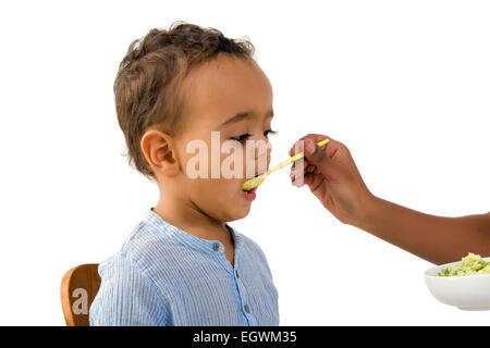 Little 18 month African toddler boy refusing to eat his vegetables Stock Photo