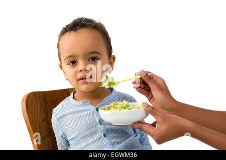 Little 18 month African toddler boy refusing to eat his vegetables Stock Photo