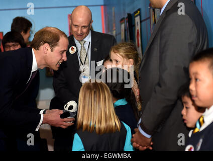Shanghai, China. 3rd Mar, 2015. Britain's Prince William (L) receives a gift from a girl during the Chinese premiere of 'Paddington' at Shanghai Film Museum in Shanghai, east China, March 3, 2015. Credit:  Jin Liangkuai/Xinhua/Alamy Live News Stock Photo