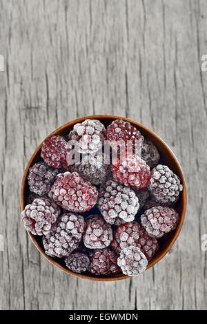 frozen blackberries on old wood table Stock Photo