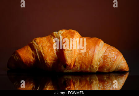 Fresh Croissant Isolated on a mirror surface Stock Photo