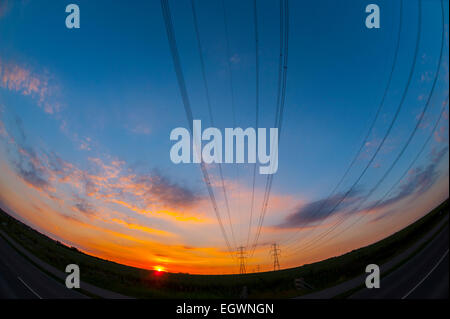 Power lines at sunset near kingsnorth power station Kent. Stock Photo