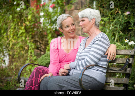 A daughter looking after her mother who is suffering from Alzeimer's. Stock Photo