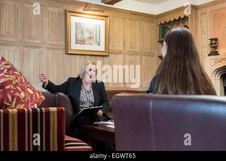 a professional business woman / wedding planner conducts a coffee table meeting with a client in an english country hotel Stock Photo