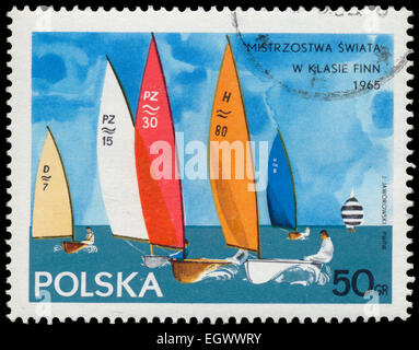 POLAND - CIRCA 1965: Stamp printed in Poland shows Yacht with the inscription and name of the series 'Championships in the Finn  Stock Photo