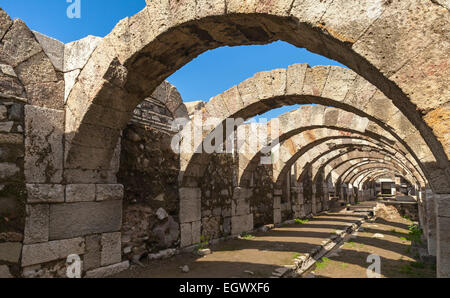 Empty corridor with arcs and blue sky. Ruins of Ancient city Smyrna. Izmir, Turkey Stock Photo