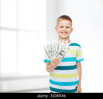 smiling boy holding dollar cash money in his hand Stock Photo