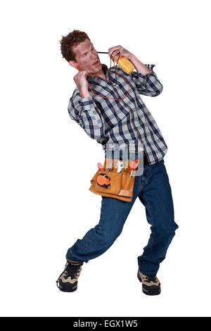 A dazed electrician suffering from electric shock Stock Photo