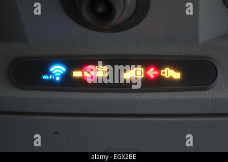 No smoking sign on airplane. Wi-Fi sign. Fasten Seat belt sign. Stock Photo