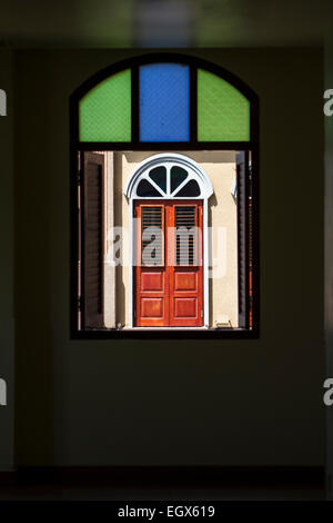 Wooden windows seen through stained glass window Stock Photo