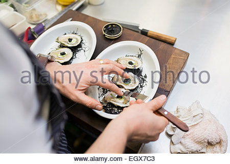 Chef preparing oysters in bowl