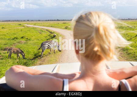Woman on african wildlife safari. Stock Photo