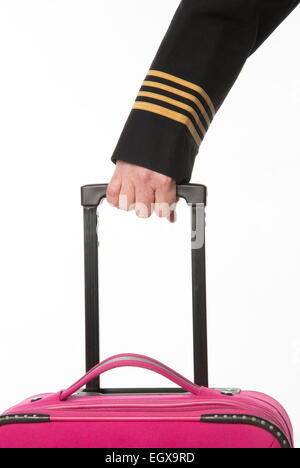Four gold rings on airline officers uniform wearing gloves and with a carry on bag Stock Photo