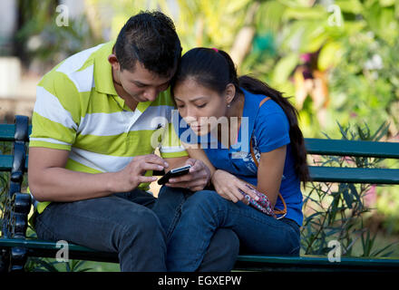 Young Mayan couple in Plaza de Independencia, Merida, Yucatan, Mexico Stock Photo