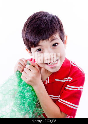 Boy enjoying bubble wrap. Stock Photo