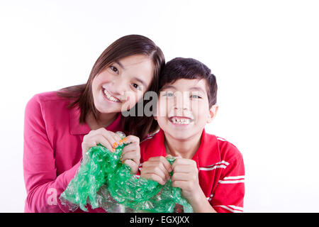 Siblings popping bubble wrap. Stock Photo