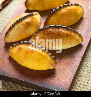 Traditional Bolivian savory pastries called Saltena filled with a kind of thick stew with meat Stock Photo