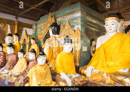 Buddha statues at Shwedagon Pagoda main stupa gold dome domed buddhist buddhism monument holy religion religious yangon myamnar Stock Photo