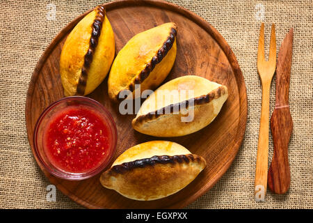 Overhead shot of traditional Bolivian savory pastries called Saltena filled with thick meat stew Stock Photo