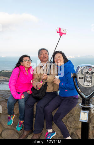 tourists, family, taking selfie, selfie photo, selfie stick, cellphone, Vista Point, north side of Golden Gate Bridge, Sausalito, California