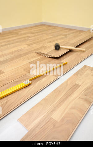 Installing wooden laminate flooring in room Stock Photo