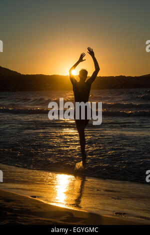 Young man, silhouette, jumping on the beach at sunset, sunset by the sea, Haute-Corse, Corsica, France Stock Photo