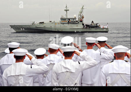 US Navy Sailors aboard the guided-missile destroyer USS Sampson salute as the Australian Armidale-class patrol boat HMAS Larrakia prepares to place a wreath during a ceremony commemorating the 73rd anniversary of the Battle of Sunda Strait March 1, 2015 in the Java Sea. Australia, the U.S. and Indonesia held a ceremony at the site of the sinking of the HMAS Perth and USS Houston sank during fighting Japanese naval forces March 1, 1942.  More than 1,000 Australian and U.S. Sailors gave their lives during the battle. Stock Photo