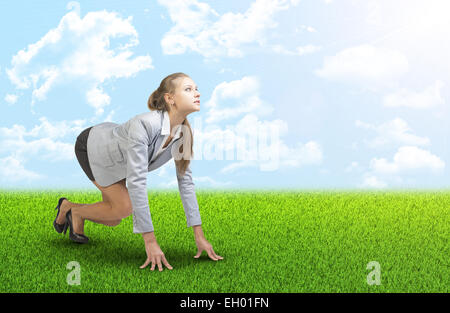 Woman on grass field with blue sky, clouds Stock Photo