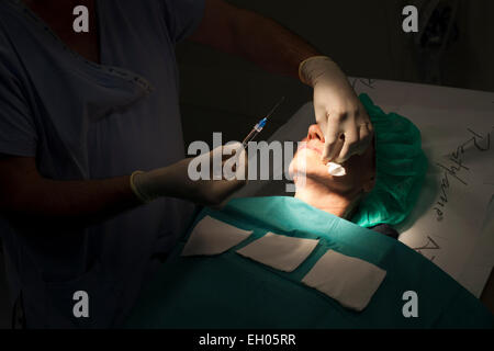 Middle-aged woman having a botox injection. Stock Photo